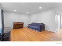 Bright living room featuring hardwood floors and piano, creating an inviting space at 690 W 1St Ave, Broomfield, CO 80020