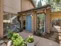 Inviting entrance with blue door, large windows, brick accents, and well-manicured landscaping at 700 Poplar Ave, Boulder, CO 80304