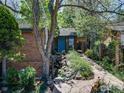Beautiful home with a blue front door, lush greenery, and a stone-lined pathway leading to the entrance at 700 Poplar Ave, Boulder, CO 80304