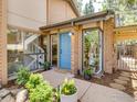 Inviting home exterior with a blue front door, manicured landscaping, and large windows showcasing the interior at 700 Poplar Ave, Boulder, CO 80304