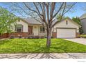 Beautifully landscaped front yard with a charming single-Gathering home and a two-car garage at 741 Hallmark Ln, Longmont, CO 80504