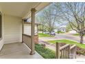 Covered front porch offers a welcoming view of the neighborhood street at 741 Hallmark Ln, Longmont, CO 80504