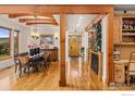 Elegant dining room with wood beams, hardwood floors, and an open floor plan with mountain views at 750 Left Fork Rd, Boulder, CO 80302