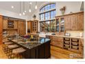 Spacious kitchen featuring a large island, wood cabinets, and modern appliances with great natural light at 750 Left Fork Rd, Boulder, CO 80302