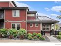 Beautiful home showing siding details, an inviting front porch, solar panels, and charming front landscaping at 860 Widgeon Dr, Longmont, CO 80503