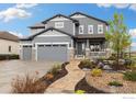 Beautiful two-story home with a three-car garage and a landscaped front yard at 916 Rocky Ridge Cir, Erie, CO 80516
