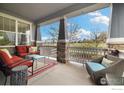 Relaxing outdoor porch with comfortable seating and a view of the surrounding landscape at 916 Rocky Ridge Cir, Erie, CO 80516