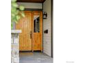 Inviting wooden front door with sidelight and traditional hardware, enhancing the entryway's charm at 1108 Grant Ave, Louisville, CO 80027