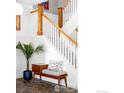 Elegant staircase with white railings and wooden accents, complemented by stylish decor at 1108 Grant Ave, Louisville, CO 80027