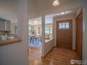 Inviting entryway featuring hardwood floors and open access to the dining and living areas at 11361 Flatiron Dr, Lafayette, CO 80026