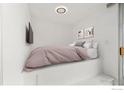 Cozy bedroom featuring built-in platform bed, closet, and natural light at 1155 N Ash St # 1206, Denver, CO 80220