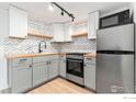 Well-lit kitchen boasts stainless appliances, stylish countertops, and ample cabinet space at 1155 N Ash St # 1206, Denver, CO 80220