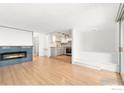 Inviting living room showcases a modern fireplace and seamless connection to the updated kitchen at 1155 N Ash St # 1206, Denver, CO 80220