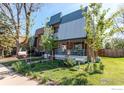 Two-story exterior view of home with attractive landscaping, lawn, and charming front porch at 11656 Logan St, Northglenn, CO 80233