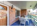 Outdoor table and seating on the covered front porch of a brick house at 11656 Logan St, Northglenn, CO 80233