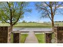 Scenic view from the front yard showcasing the green space and distant farm at 120 E Nebraska Ave, Berthoud, CO 80513