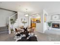 Open-concept space with dining area, open to the kitchen and living room at 12711 Colorado Blvd # H-804, Thornton, CO 80241