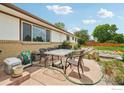 Enjoy outdoor living on the patio with seating area, lush landscaping, and a serene atmosphere at 12734 Anhawa Ave, Longmont, CO 80503