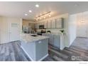 Modern kitchen with granite countertops, stainless steel appliances, and a functional island at 1295 Cumberland Dr, Longmont, CO 80504