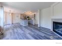 Open-concept living area with a fireplace, seamlessly connecting the living room to the kitchen at 1295 Cumberland Dr, Longmont, CO 80504