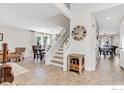Bright foyer with a staircase, views into the dining area and the front living room at 1304 Monarch Ct, Longmont, CO 80504
