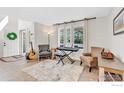 Inviting living room with neutral decor, large windows, and musical instruments on display at 1304 Monarch Ct, Longmont, CO 80504