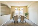 Formal dining room featuring modern furnishings and a chandelier fixture at 1404 Tonkin Pl, Longmont, CO 80504