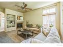 Cozy living room featuring a fireplace, built-in shelving, and comfortable seating at 1404 Tonkin Pl, Longmont, CO 80504
