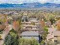 Expansive aerial view of a neighborhood with mountain views and mature trees at 2026 Braeburn Ct, Longmont, CO 80503
