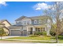 Charming two-story home boasts a three-car garage and meticulously landscaped front yard at 2026 Braeburn Ct, Longmont, CO 80503