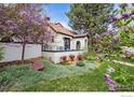 Charming single-Gathering home featuring a lush garden with blooming trees and shrubs at 229 Albion St, Denver, CO 80220