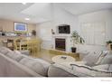Bright living room with a fireplace, light wood floors, and large windows at 2315 Walnut St, Boulder, CO 80302
