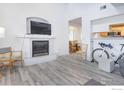 Open concept living room featuring a fireplace with a mounted TV and a view into the breakfast nook and kitchen at 2317 Walnut St, Boulder, CO 80302