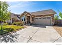 Inviting single-Gathering home with a stone facade, a two-car garage, and a concrete driveway at 2422 E 156Th Pl, Thornton, CO 80602