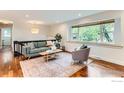 Comfortable living room with hardwood floors, a large window, and stylish decor at 2550 Woodstock Pl, Boulder, CO 80305