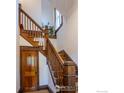 Traditional wooden staircase with wood door and trim, featuring a window allowing natural light at 2645 5Th St, Boulder, CO 80304