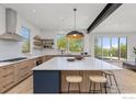 Spacious kitchen featuring a large island, modern appliances, custom cabinetry, and hardwood floors at 2814 3Rd St, Boulder, CO 80304