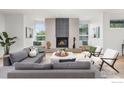 Bright living room with a modern fireplace, light hardwood floors, and large windows offering outdoor views at 2814 3Rd St, Boulder, CO 80304