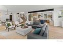 Open-concept living space with modern furniture, stainless steel staircase, and a view of the kitchen at 2814 3Rd St, Boulder, CO 80304