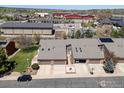 Aerial view of townhomes with garages, showcasing the community layout and surrounding neighborhood amenities at 2875 W Davies Ave, Littleton, CO 80120