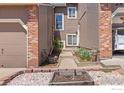 Close-up of a townhome entry with a landscaped walkway, offering a private and welcoming entrance at 2875 W Davies Ave, Littleton, CO 80120