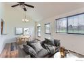 Inviting living room featuring vaulted ceiling, new paint, lots of natural light, and stylish decor at 305 S Taft Ct, Louisville, CO 80027
