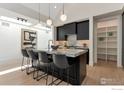 Spacious kitchen with marble counters, island seating, modern cabinets, and stainless appliances at 306 S 3Rd Ave, Superior, CO 80027