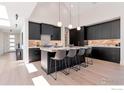 Elegant kitchen featuring black cabinets, marble countertops, and seating at the island at 306 S 3Rd Ave, Superior, CO 80027
