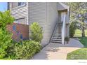 Close up exterior view of townhome showing siding, stairs, and greenery at 3260 47Th St # 201A, Boulder, CO 80301