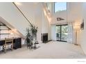 Bright living room with vaulted ceilings, fireplace, and access to balcony at 3260 47Th St # 201A, Boulder, CO 80301