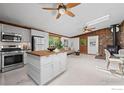 Bright open floor plan with wood-burning stove, island, and many windows at 41 Silver Spruce, Boulder, CO 80302