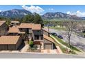 Aerial shot of a two-story home showcasing landscaping, mountains, and surrounding neighborhood at 4100 Greenbriar Blvd, Boulder, CO 80305