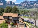 Exterior view of a multi-story home with beautiful mountain views in the background at 4100 Greenbriar Blvd, Boulder, CO 80305