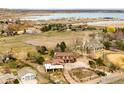 Sprawling property with mature trees, a large pond, and a variety of structures at 4963 Kelso Rd, Boulder, CO 80301